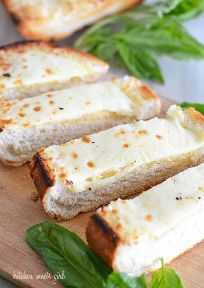Easy Cheesy Garlic bread on kitchenmeetsgirl.com - don't buy those presliced loaves from your grocer when you can make a loaf like this at home! So gooey and cheesy and perfectly seasoned! #recipes #bread