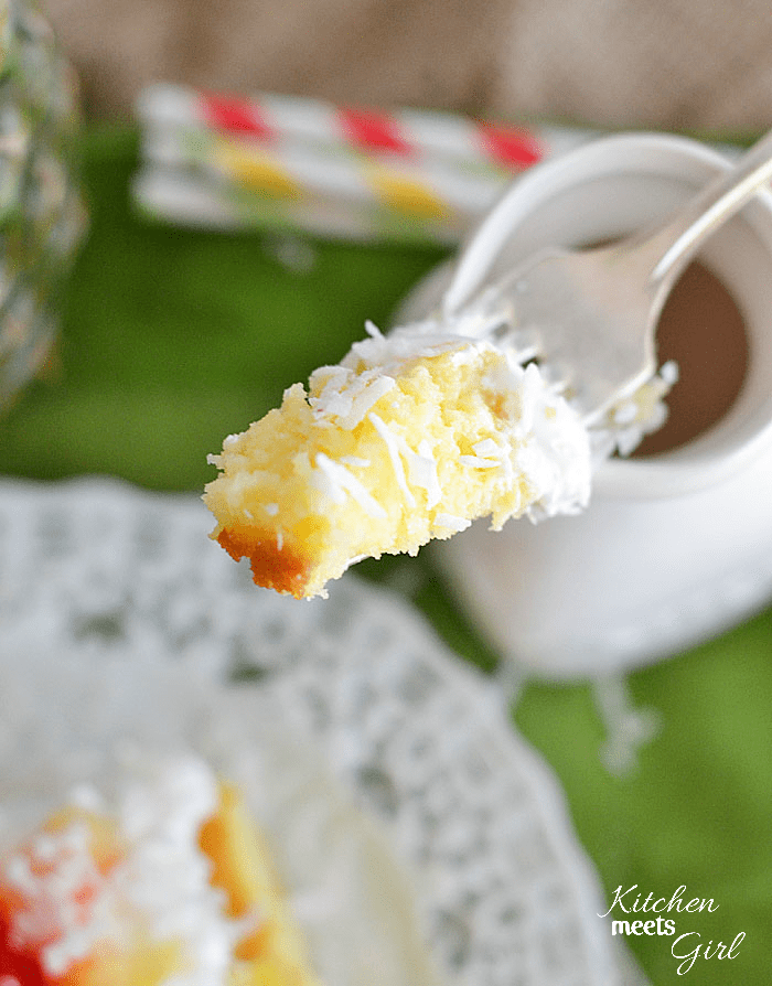 Pina Colada Poke Cake from www.kitchenmeetsgirl.com - so SIMPLE to make and absolutely DELICIOUS! #recipe #cake #pineapple #coconut
