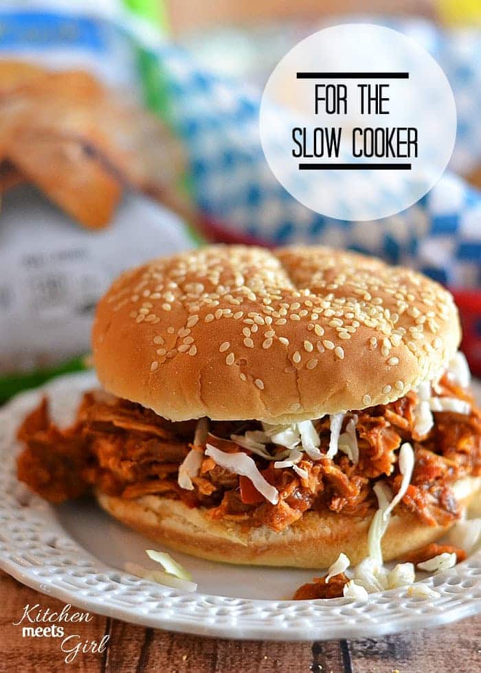 Simmered in a tangy sauce, this tender, spicy chicken is perfect on sandwiches, in tacos, or on a salad! #recipe #chicken #slow cooker