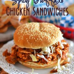Simmered in a tangy sauce, this tender, spicy chicken is perfect on sandwiches, in tacos, or on a salad! #recipe #chicken #slow cooker