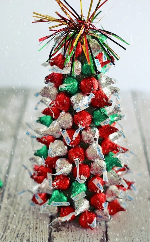 In the holiday spirit for a festive centerpiece, but aren't super crafty? These "Kiss"-mas Tree Centerpieces made with Hershey's Kisses are super easy to make and are a fun project to work on with kiddos!