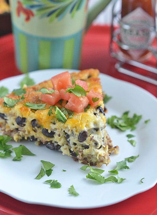 This Mexican Skillet Breakfast Casserole is sure to satisfy hungry family and friends. Filled with sausage, cheese and veggies, this hearty breakfast can be prepared the night before, making busy mornings stress-free!