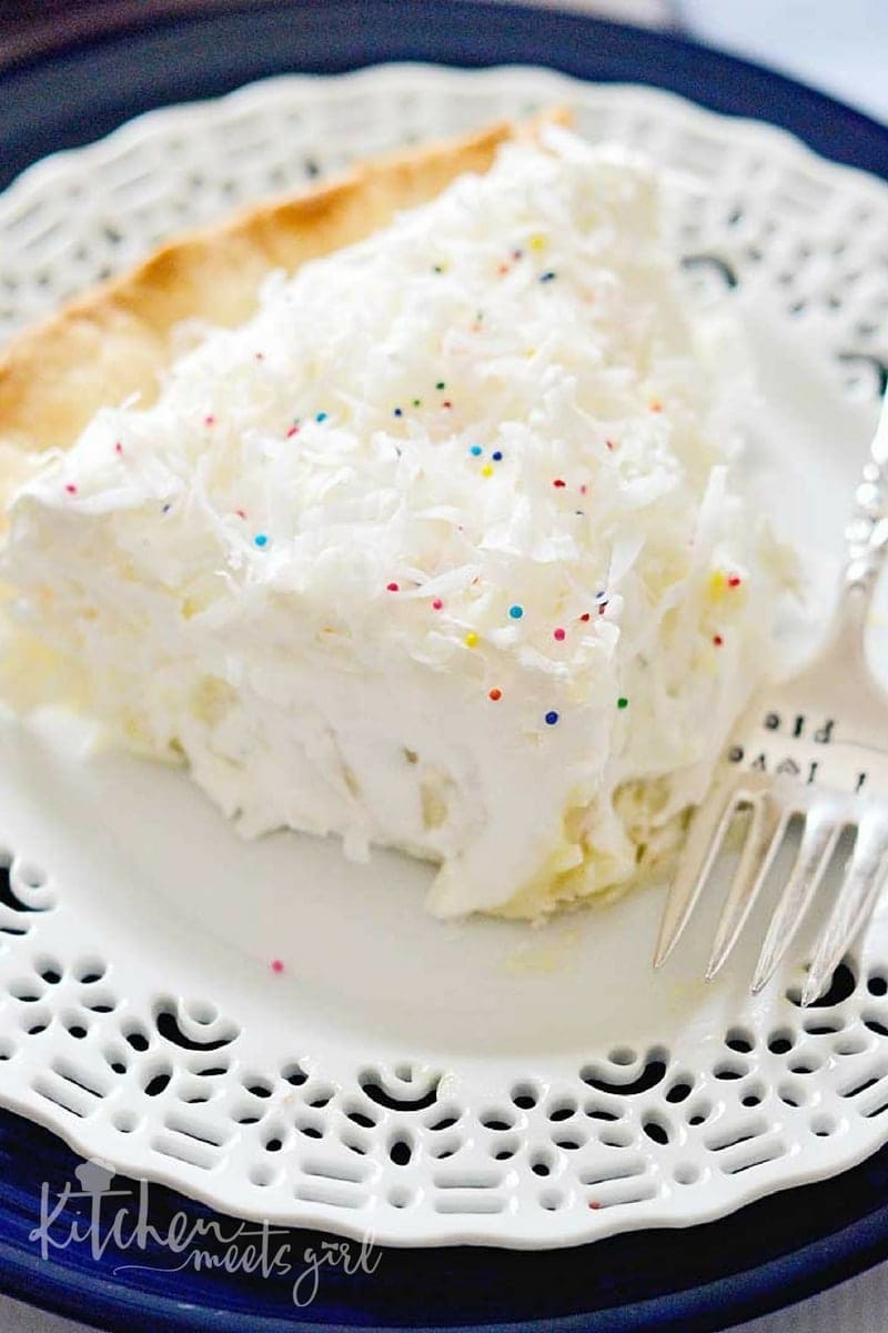 This Fluffy Coconut Cream Pie is simply divine! The custard filling is rich and smooth, and using coconut milk and coconut extract gives it an extra creamy burst of coconut flavor. Topped with homemade whipped cream, this pie is a must make any time of the year.