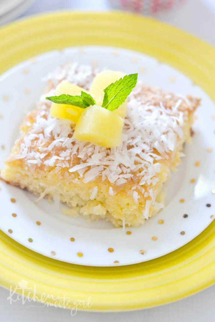 This Pineapple Bubble Cake uses crushed pineapple and pineapple juice to create a super moist, yet light and fluffy cake.  Topped with a bubbling sugary milk mixture and dusted with a sprinkling of coconut, this cake is the ultimate in tropical desserts!