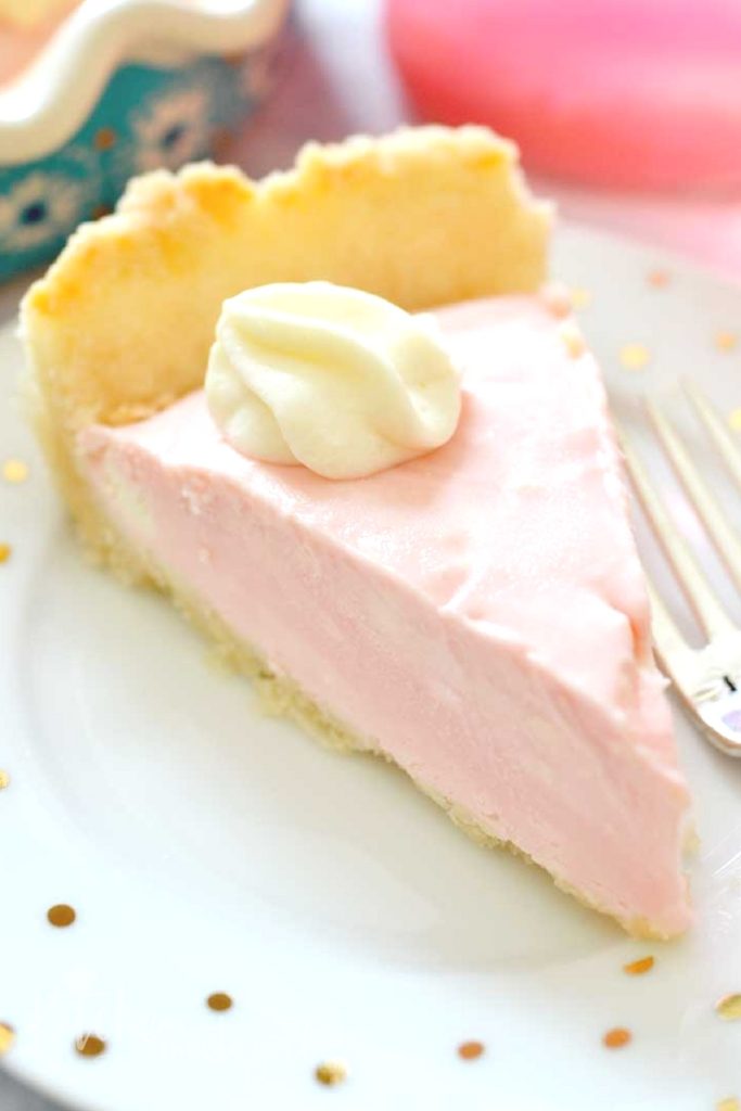 Cool Pink Lemonade Pie is just perfect for those hot summer days.  This creamy treat combines pink lemonade concentrate, cream cheese, sweetened condensed milk, and Cool Whip for a perfectly tart and fluffy pie.  You'll feel like a kid at a lemonade stand - only you'll be using a fork, not a straw!
